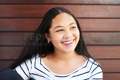 Buy stock photo Shot of a happy young girl posing against a wooden background