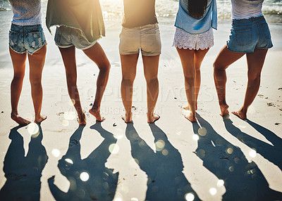 Buy stock photo Cropped shot of a group of girlfriends standing together on the beach