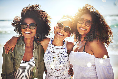 Buy stock photo Cropped shot of three friends enjoying themselves at the beach on a sunny day