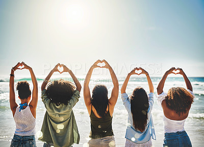 Buy stock photo Rearview shot of a group of girlfriends showing heart shapes with their hands