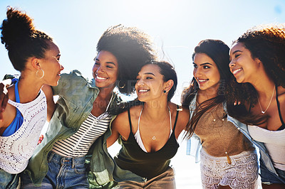 Buy stock photo Shot of a group of girlfriends spending the day at the beach
