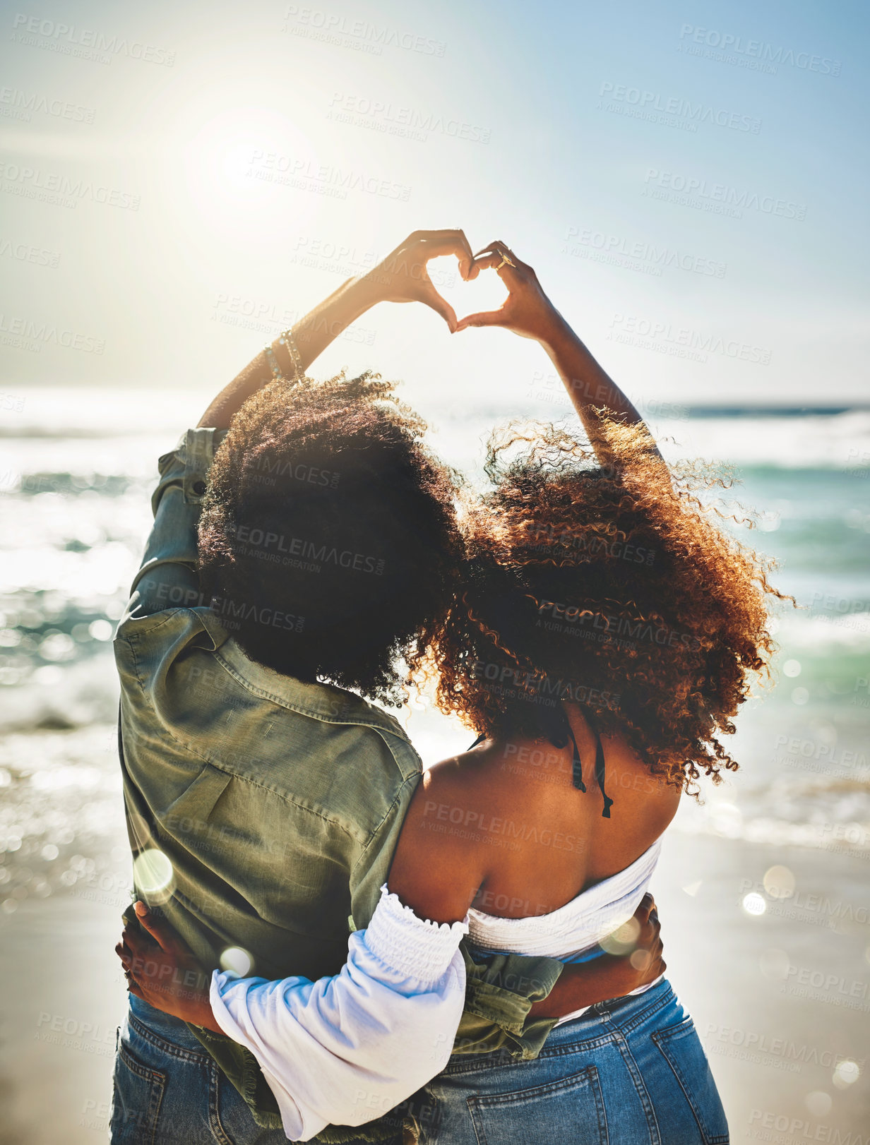 Buy stock photo Heart, couple of friends and hands together at beach for travel adventure, support embrace and bonding. Back, people and love sign emoji for sisterhood, vacation memory or relax by ocean destination