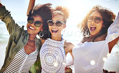 Buy stock photo Cropped shot of three friends enjoying themselves at the beach on a sunny day