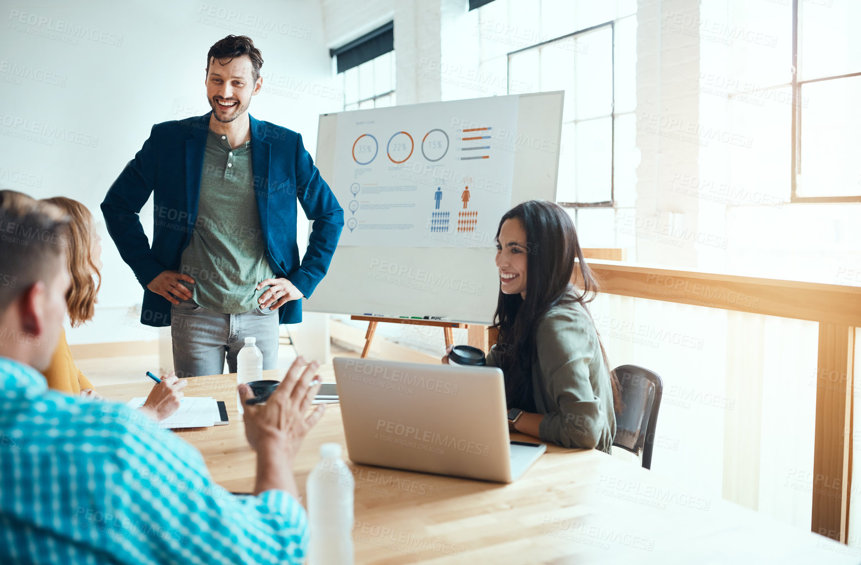 Buy stock photo Shot of a group of young businesspeople having a meeting in a modern office