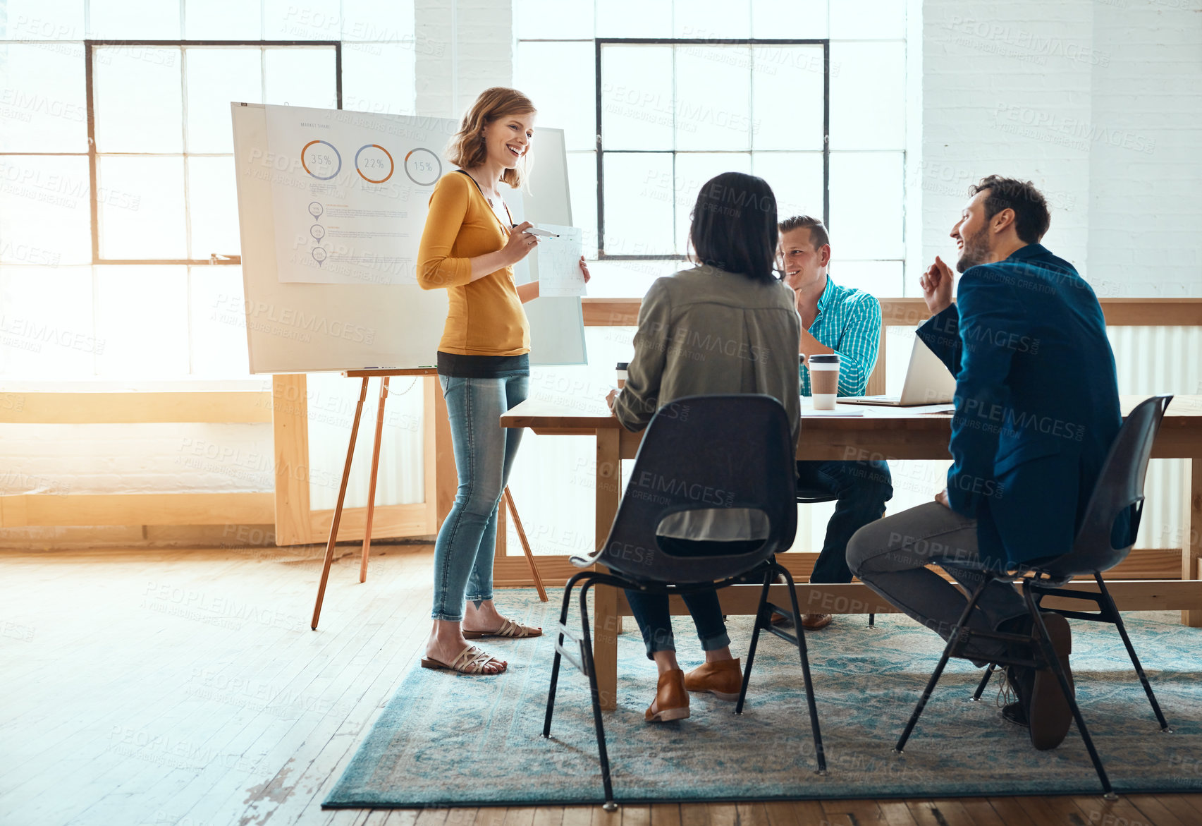 Buy stock photo Shot of a group of young businesspeople having a meeting in a modern office