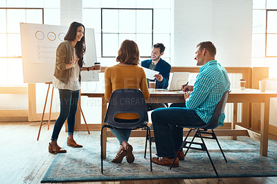 Buy stock photo Shot of a group of young businesspeople having a meeting in a modern office