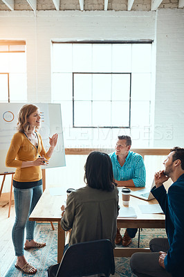 Buy stock photo Shot of a group of young businesspeople having a meeting in a modern office