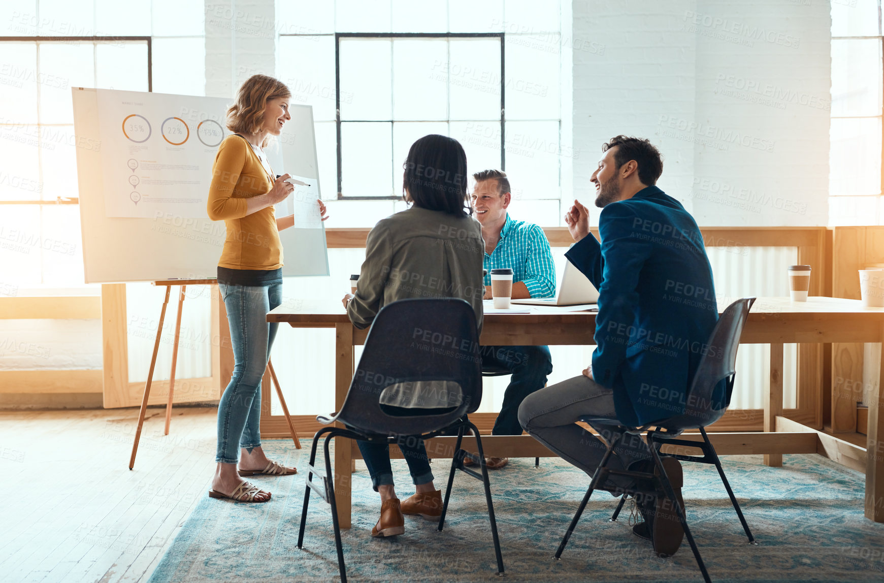 Buy stock photo Shot of a group of young businesspeople having a meeting in a modern office