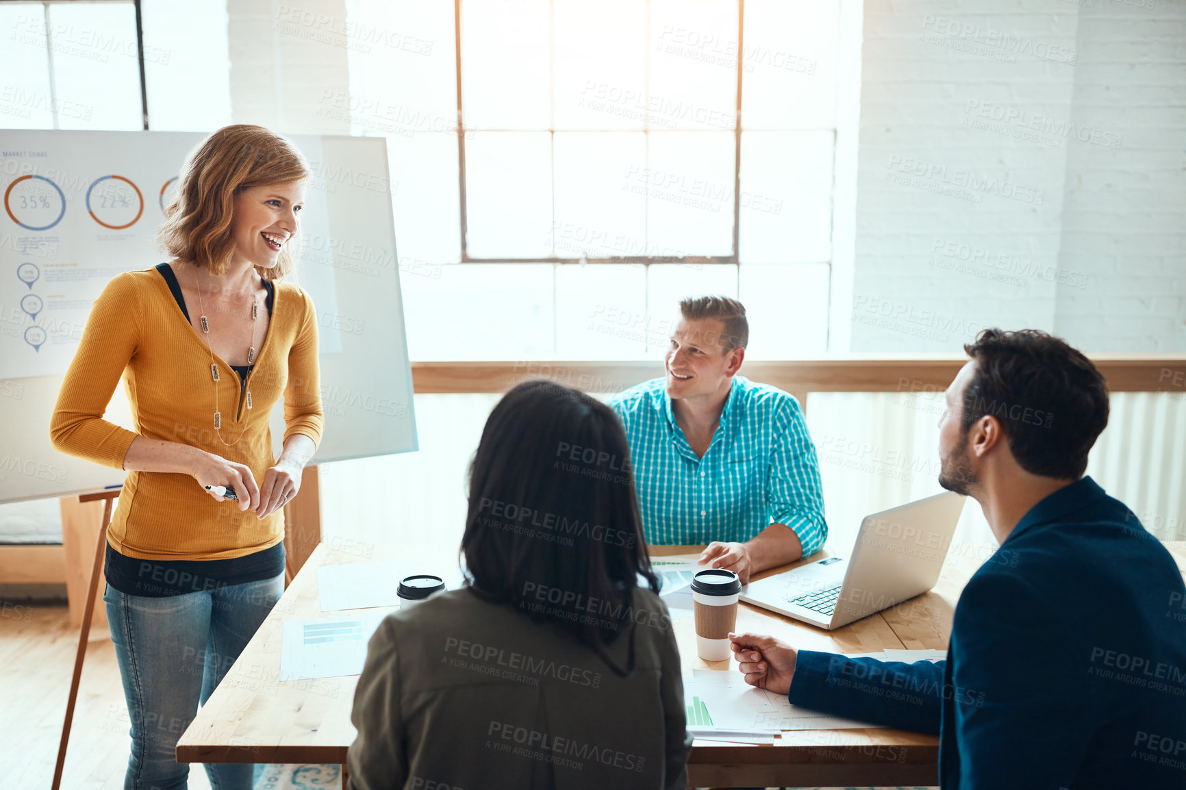 Buy stock photo Shot of a group of young businesspeople having a meeting in a modern office