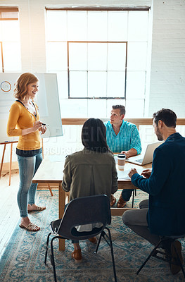 Buy stock photo Shot of a group of young businesspeople having a meeting in a modern office