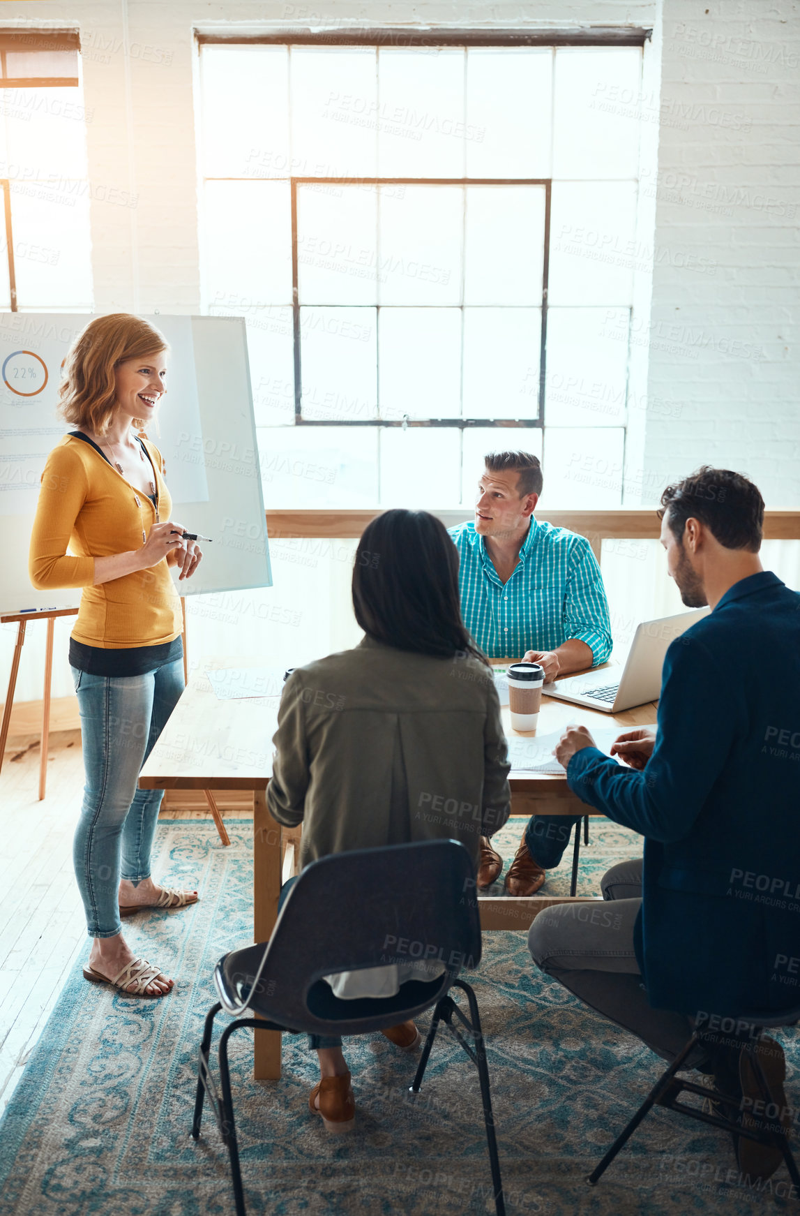 Buy stock photo Shot of a group of young businesspeople having a meeting in a modern office