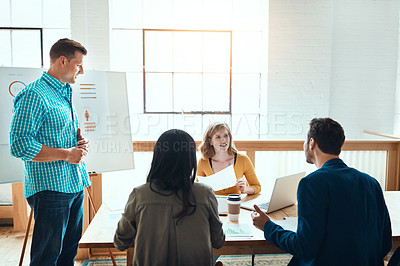 Buy stock photo Shot of a group of young businesspeople having a meeting in a modern office