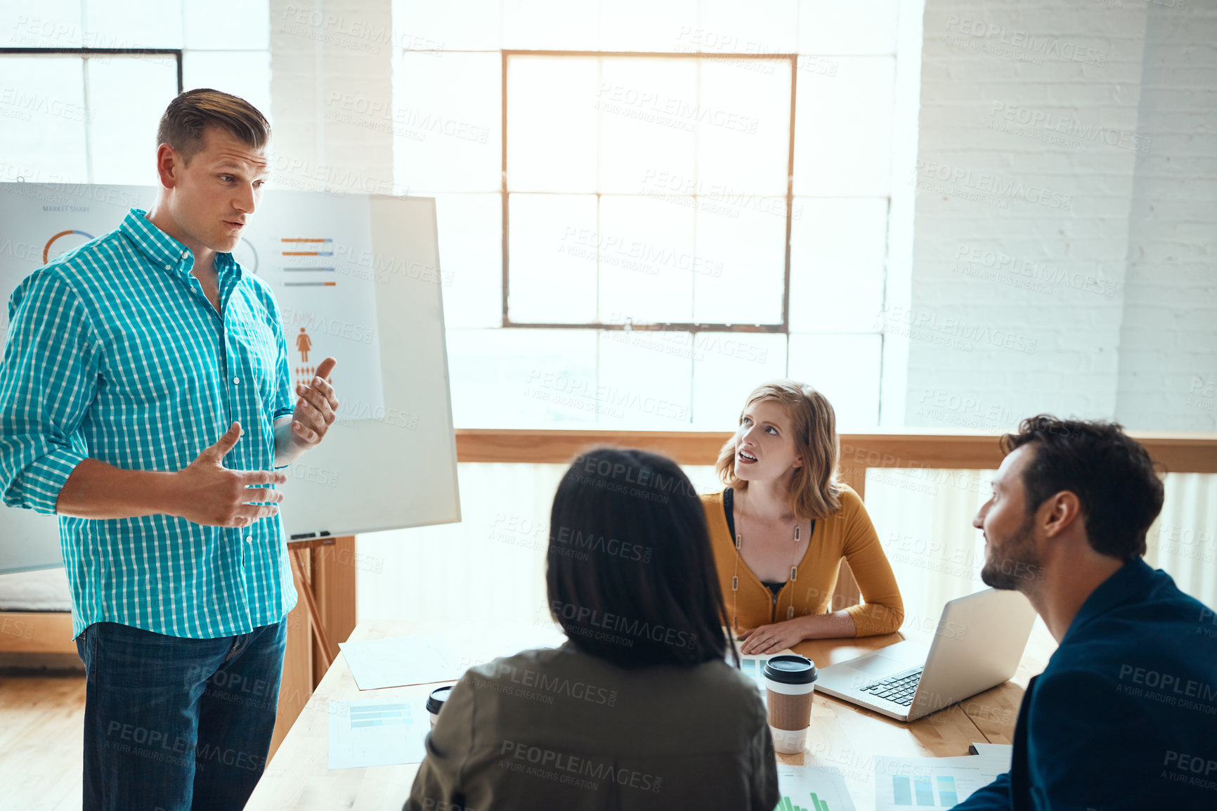 Buy stock photo Shot of a group of young businesspeople having a meeting in a modern office