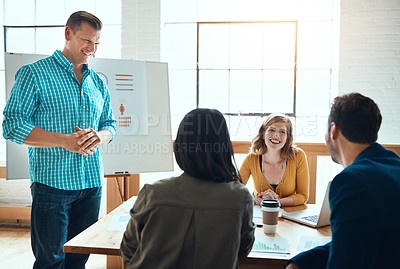 Buy stock photo Shot of a group of young businesspeople having a meeting in a modern office