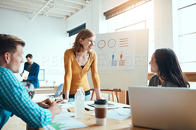 Buy stock photo Shot of a group of young businesspeople having a meeting in a modern office