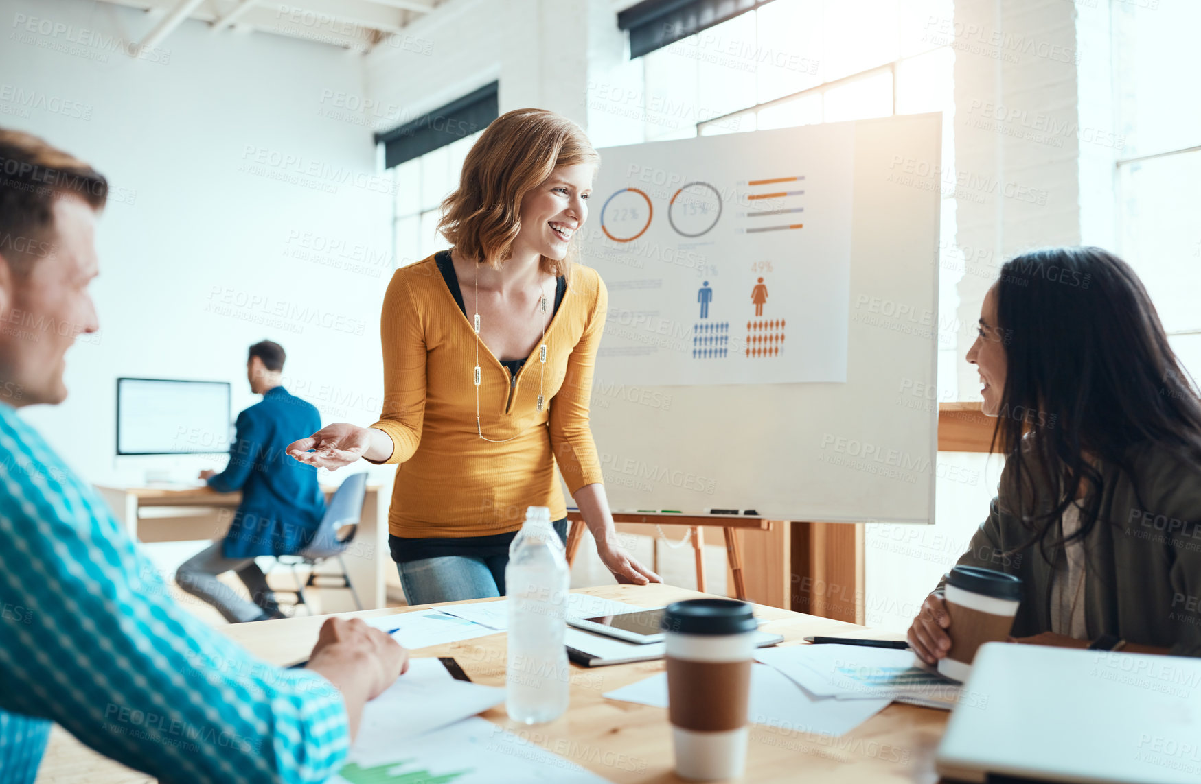 Buy stock photo Shot of a group of young businesspeople having a meeting in a modern office