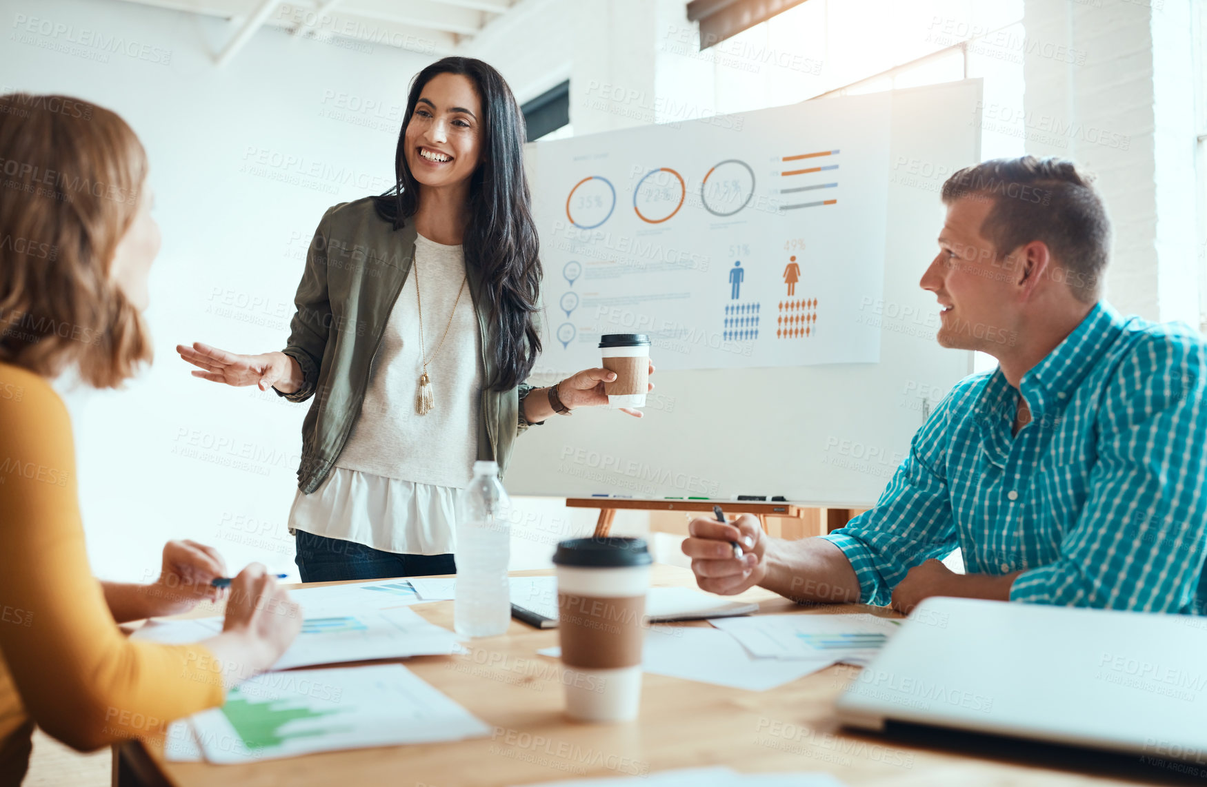 Buy stock photo Shot of a group of young businesspeople having a meeting in a modern office