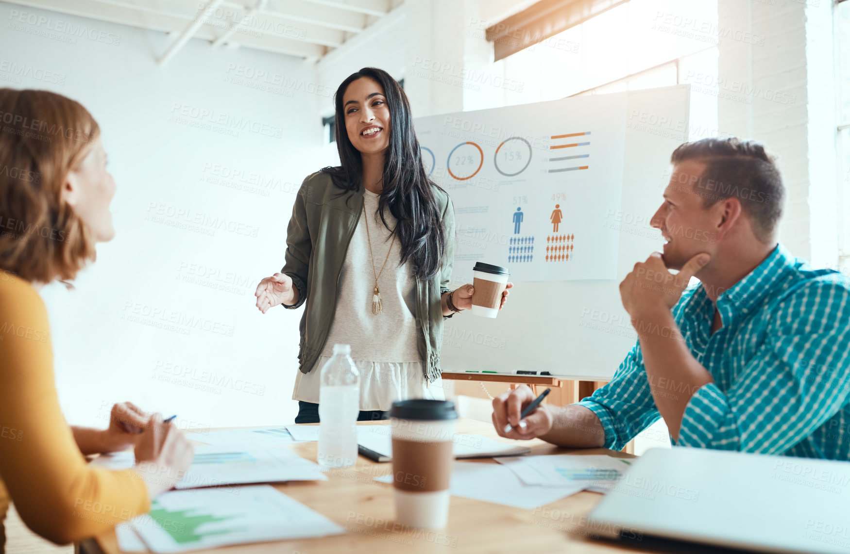 Buy stock photo Shot of a group of young businesspeople having a meeting in a modern office