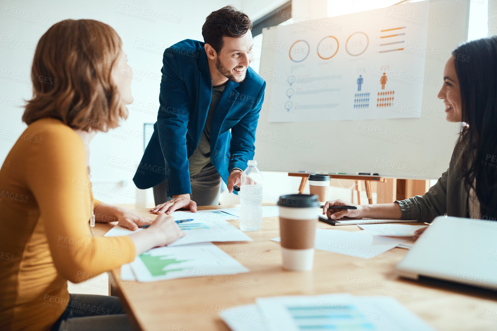 Buy stock photo Shot of a group of young businesspeople having a meeting in a modern office