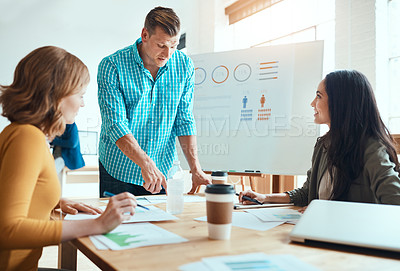 Buy stock photo Shot of a group of young businesspeople having a meeting in a modern office