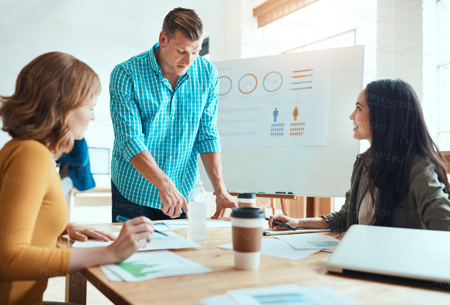 Buy stock photo Shot of a group of young businesspeople having a meeting in a modern office