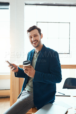 Buy stock photo Cropped portrait of a handsome young businessman using his cellphone while working in a modern office