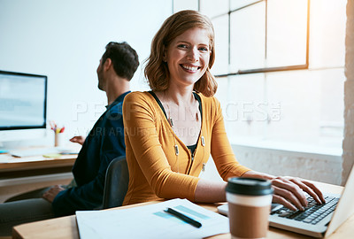 Buy stock photo Cropped portrait of an attractive young businesswoman working on her laptop in a modern office