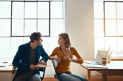 Buy stock photo Cropped shot of two young businesspeople working together in a modern office