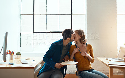 Buy stock photo Cropped shot of young couple kissing while working together in their modern office