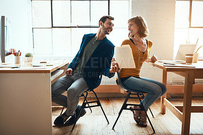 Buy stock photo Full length shot of two young businesspeople working together in a modern office