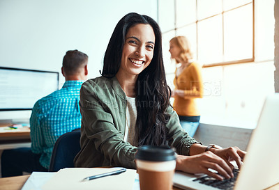 Buy stock photo Cropped portrait of an attractive young businesswoman working in a modern office with her colleagues in the background