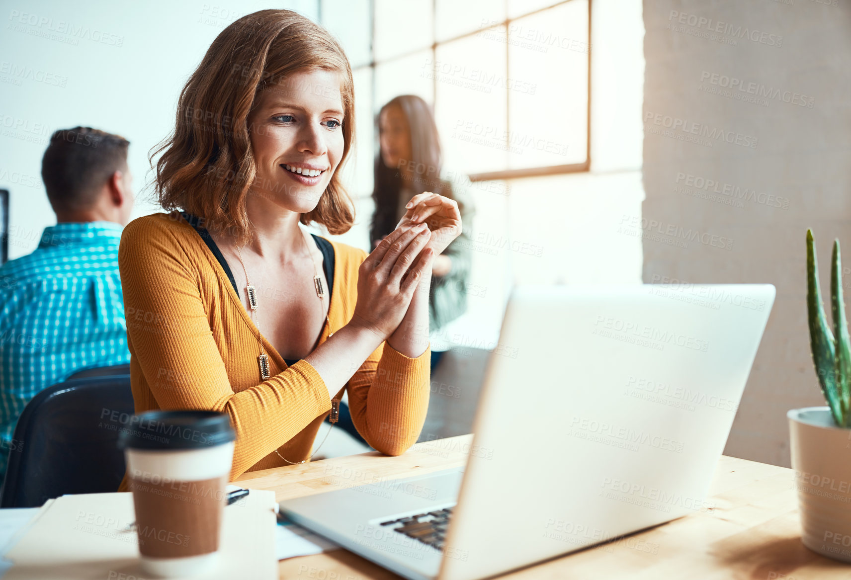 Buy stock photo Cropped shot of an attractive young businesswoman working in a modern office with her colleagues in the background