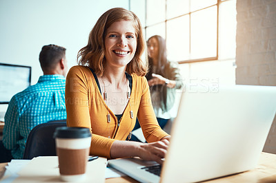 Buy stock photo Cropped portrait of an attractive young businesswoman working in a modern office with her colleagues in the background