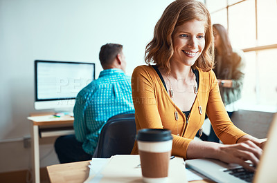 Buy stock photo Cropped shot of an attractive young businesswoman working in a modern office with her colleagues in the background