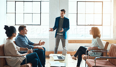 Buy stock photo Shot of a group of young businesspeople having a meeting in a modern office