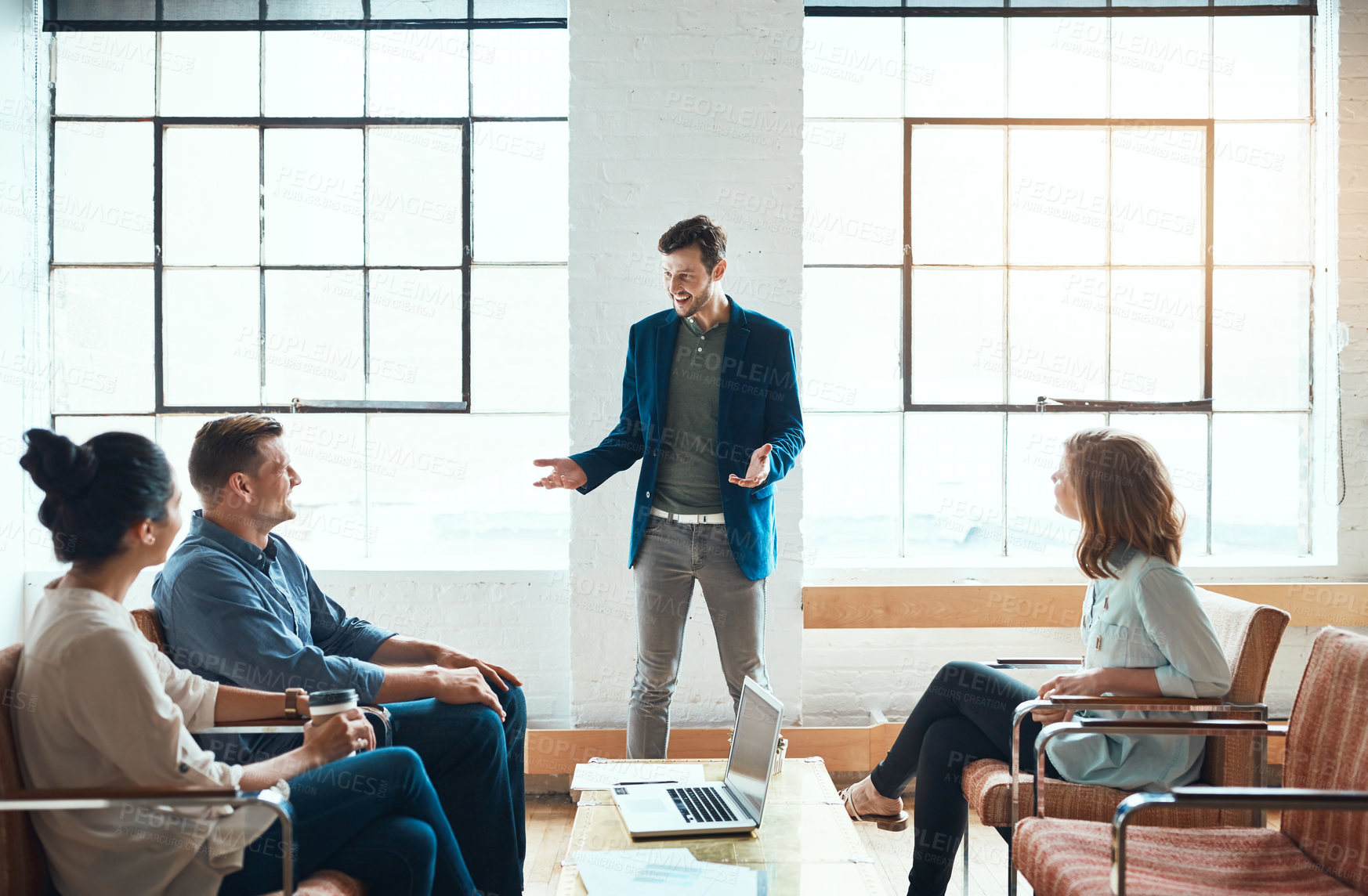 Buy stock photo Shot of a group of young businesspeople having a meeting in a modern office