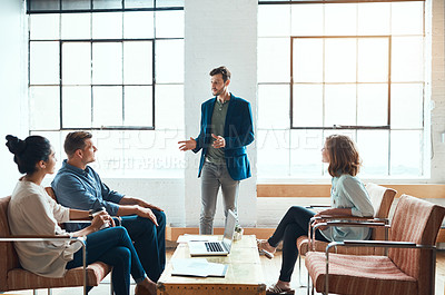 Buy stock photo Shot of a group of young businesspeople having a meeting in a modern office