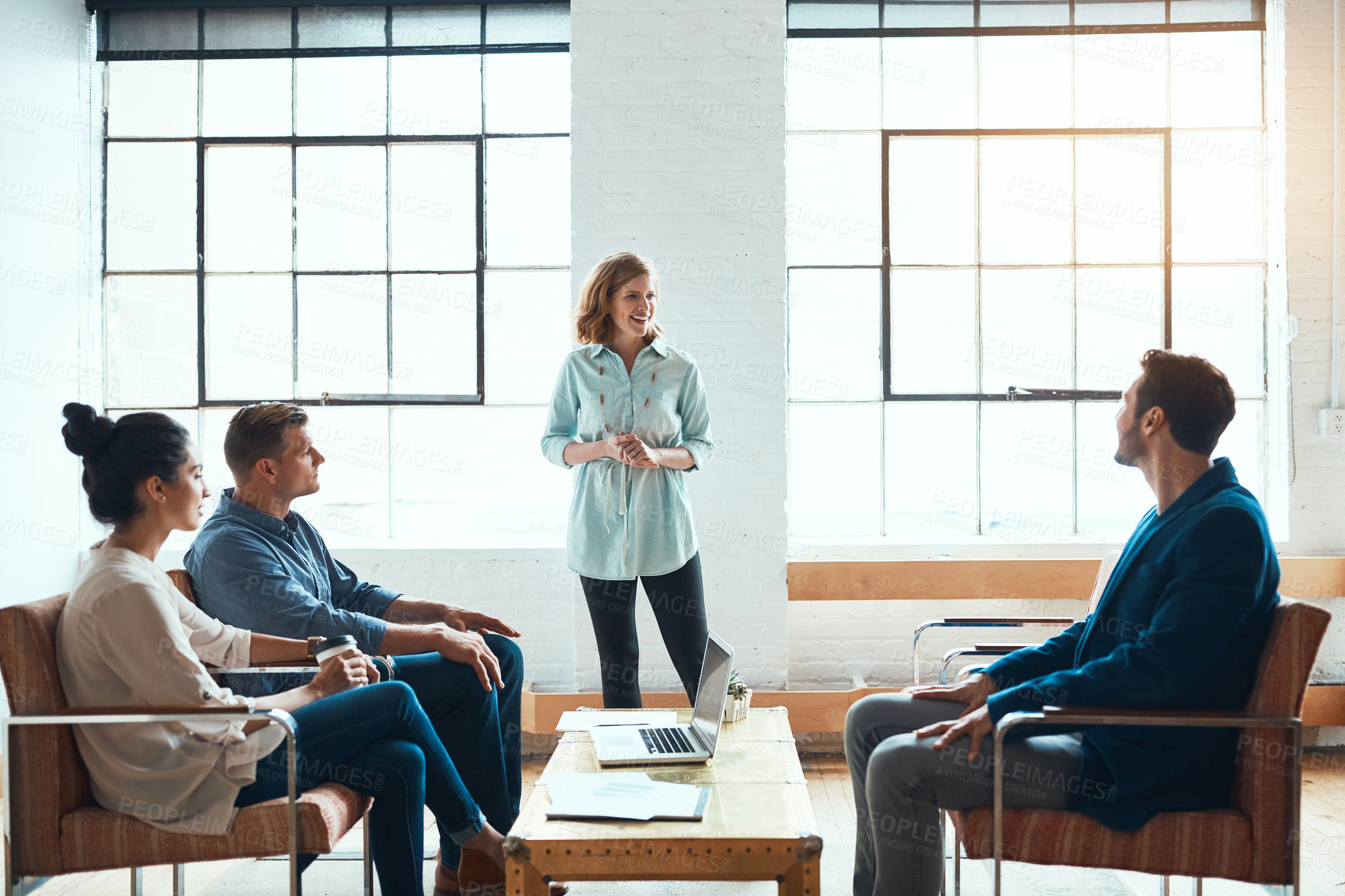 Buy stock photo Shot of a group of young businesspeople having a meeting in a modern office