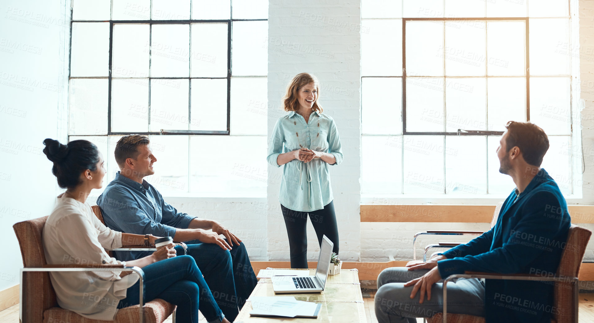 Buy stock photo Shot of a group of young businesspeople having a meeting in a modern office