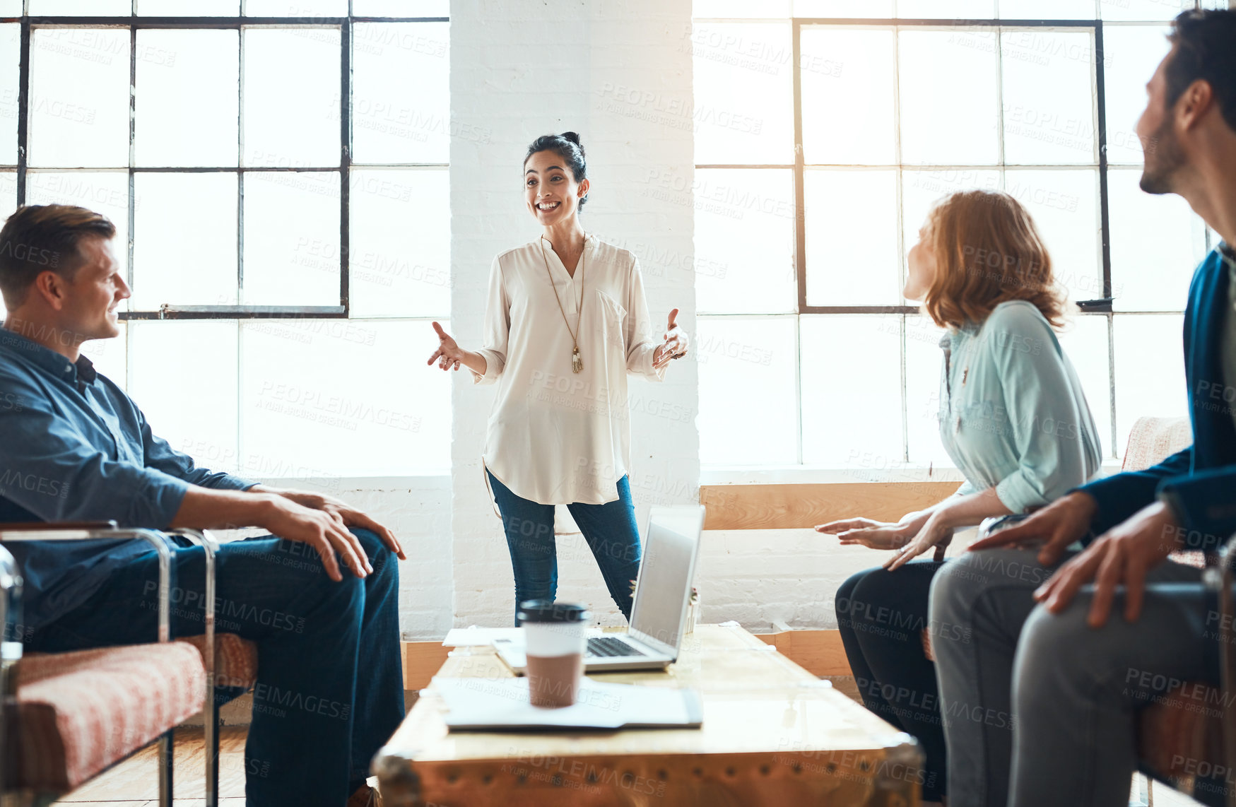 Buy stock photo Shot of a group of young businesspeople having a meeting in a modern office