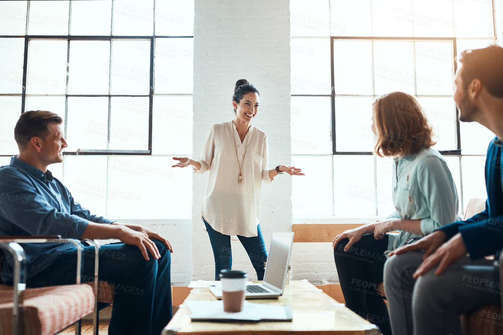 Buy stock photo Shot of a group of young businesspeople having a meeting in a modern office