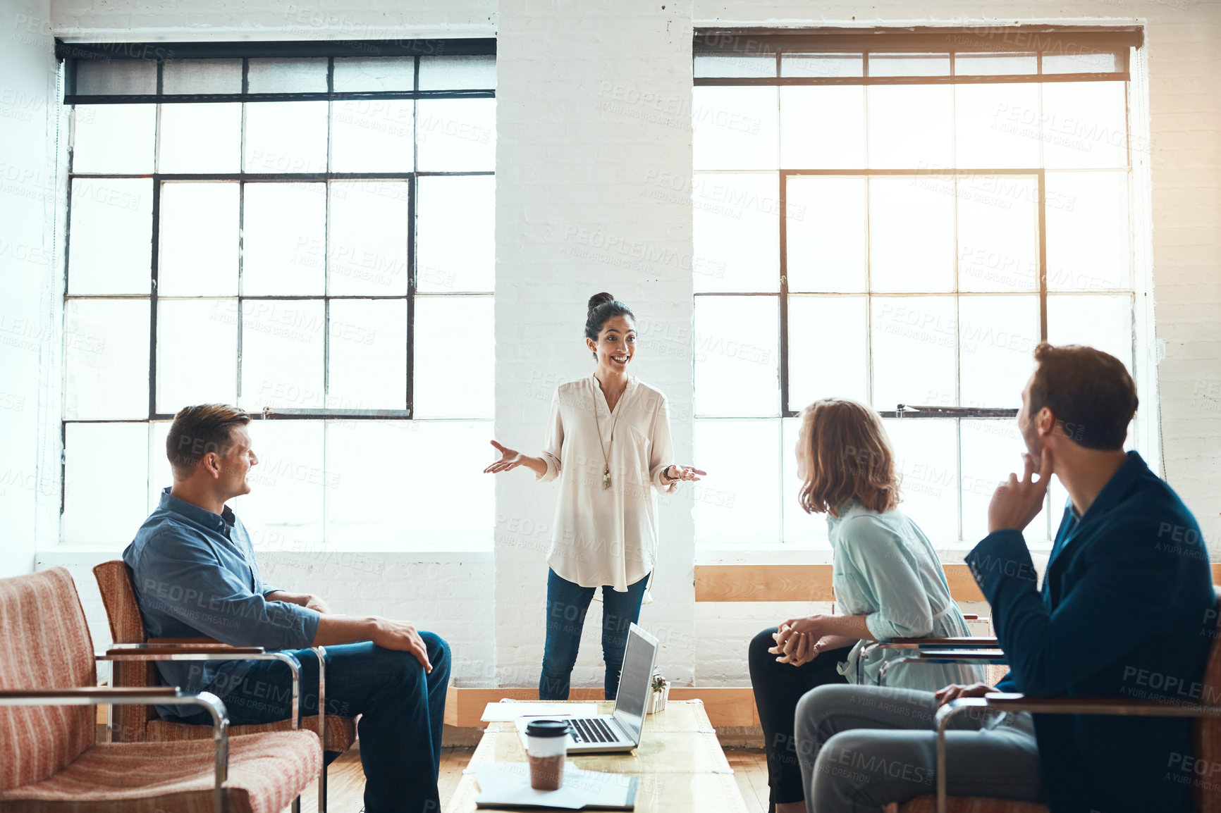 Buy stock photo Shot of a group of young businesspeople having a meeting in a modern office