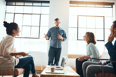 Buy stock photo Shot of a group of young businesspeople having a meeting in a modern office