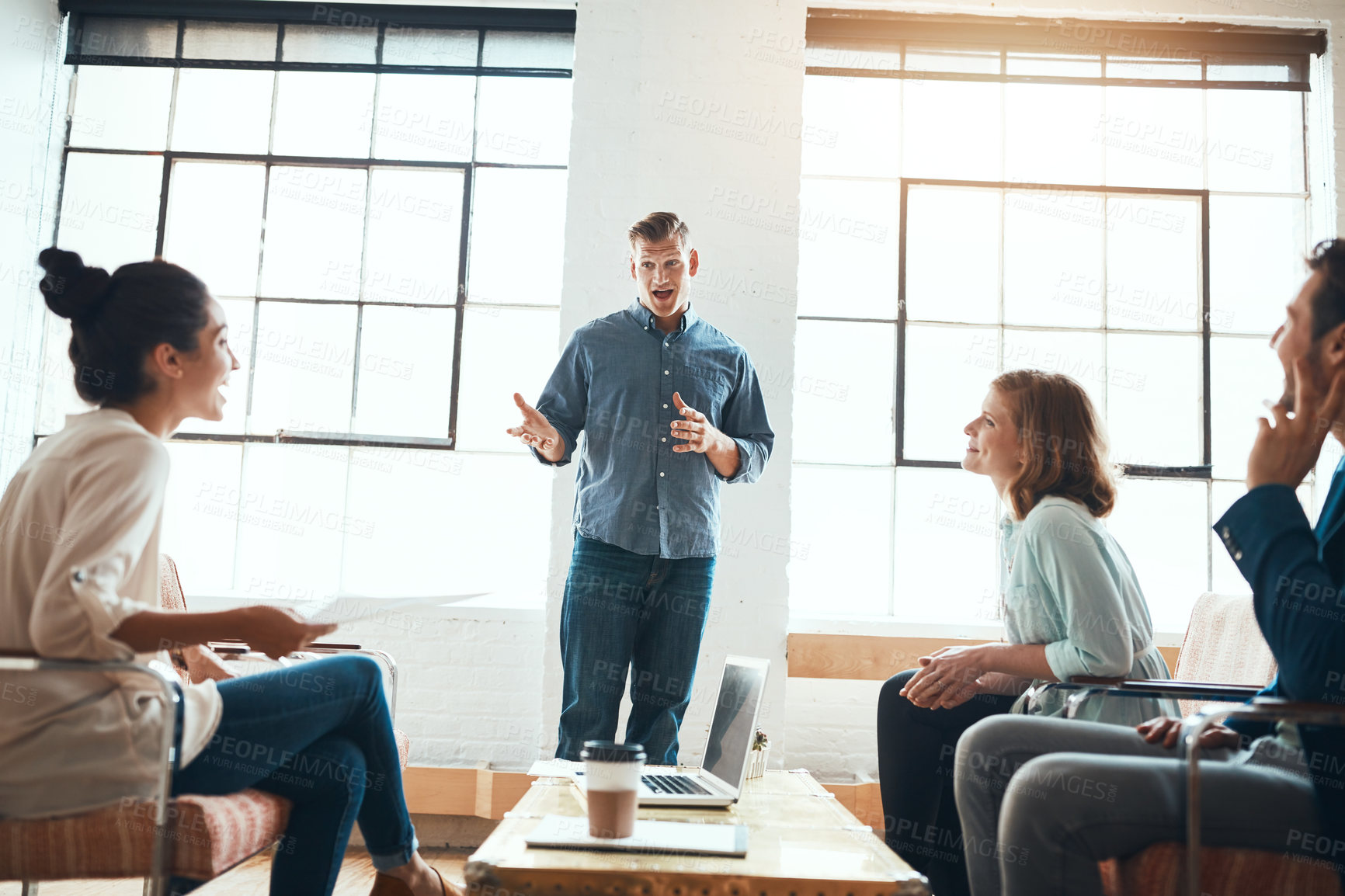 Buy stock photo Shot of a group of young businesspeople having a meeting in a modern office