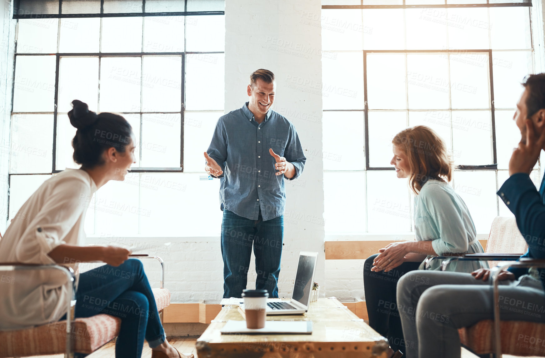 Buy stock photo Shot of a group of young businesspeople having a meeting in a modern office