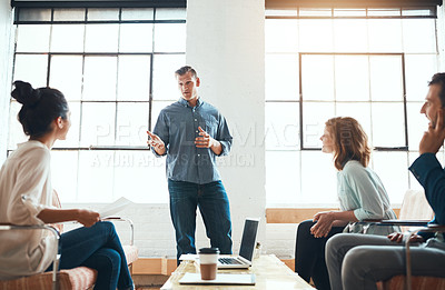 Buy stock photo Shot of a group of young businesspeople having a meeting in a modern office