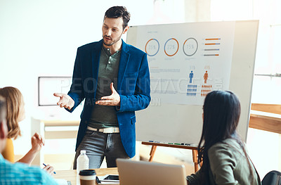 Buy stock photo Data, presentation and businessman with team in meeting at office with demographic statistics. Collaboration, project and speaker with people for population charts at training workshop in workplace.