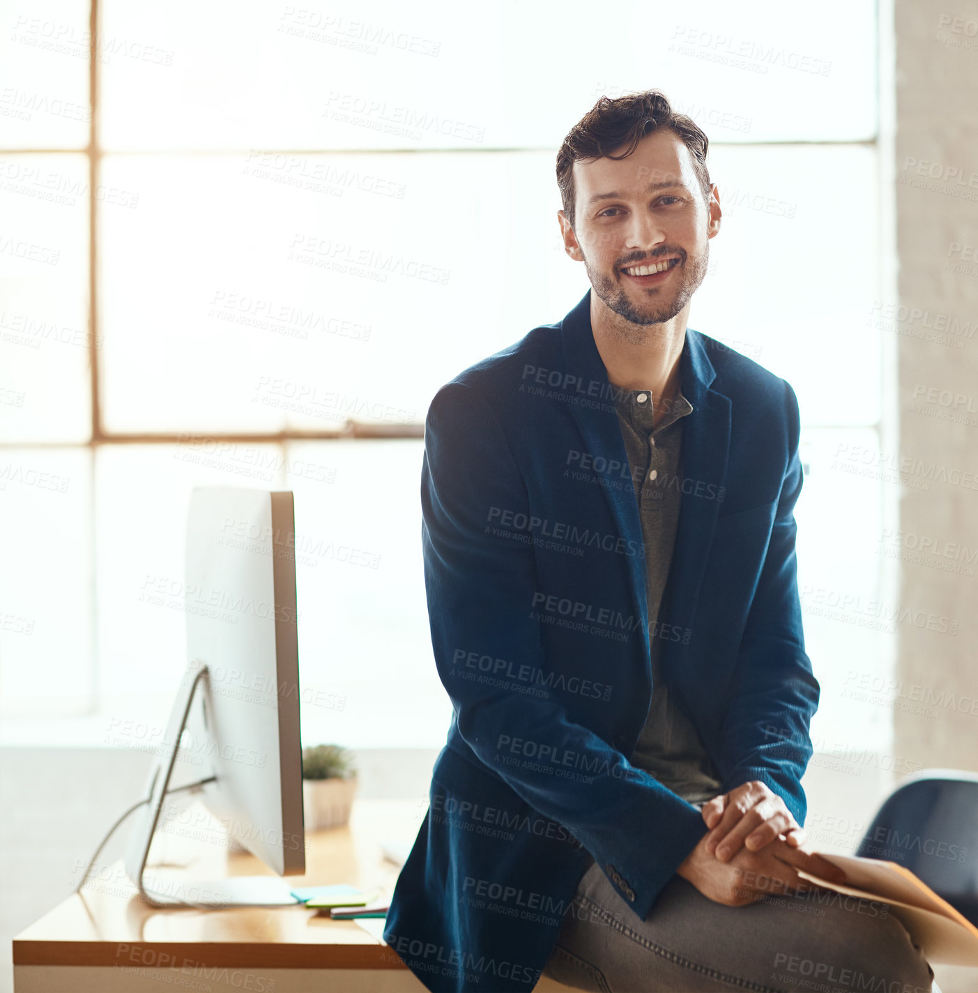 Buy stock photo Cropped portrait of a handsome young businessman working in a modern office