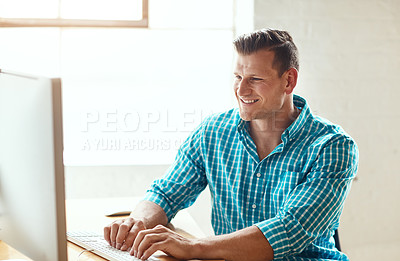 Buy stock photo Cropped shot of a handsome young businessman working on his computer in a modern office