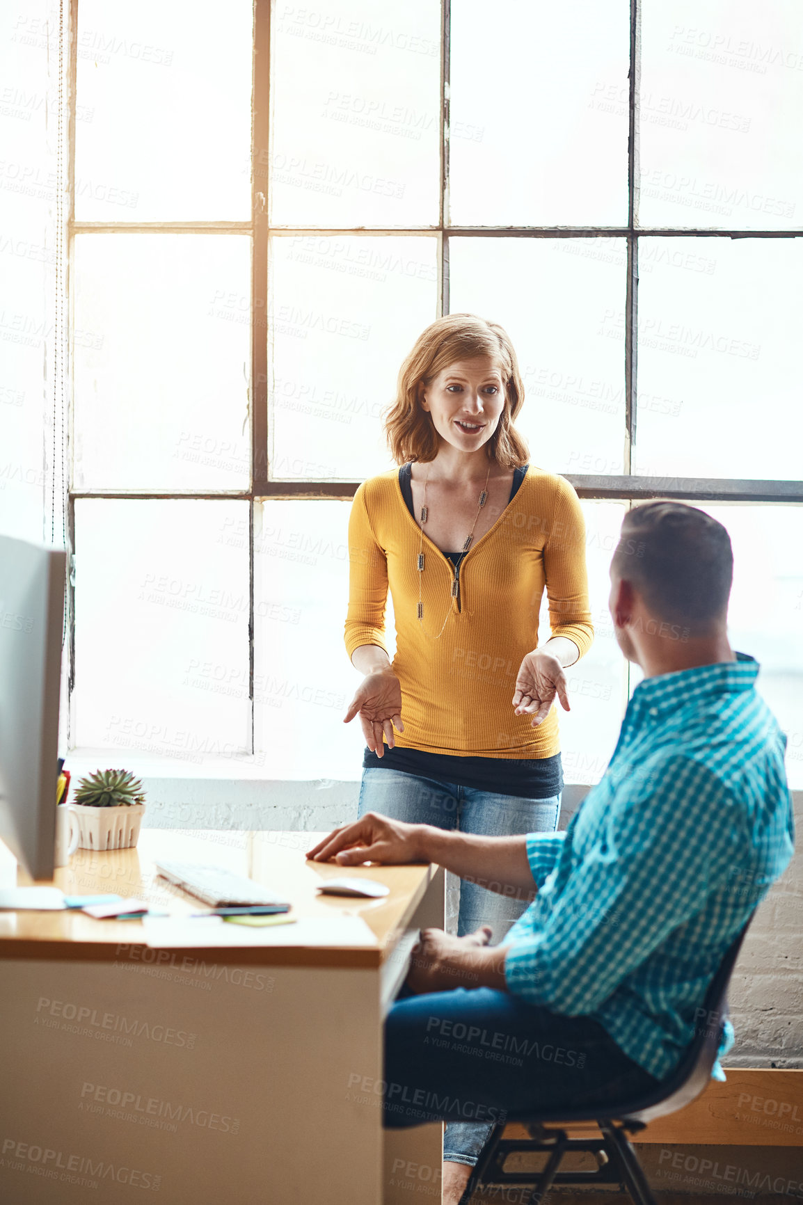 Buy stock photo Cropped shot of an attractive young businesswoman giving some advice to a male colleague while working in a modern office